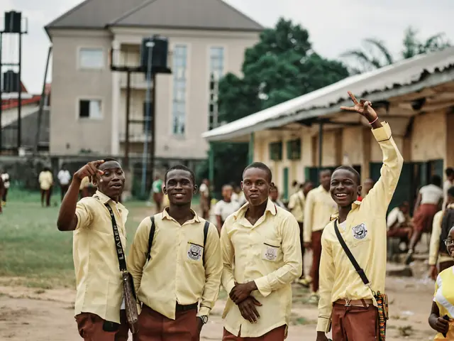 Senior secondary students in cream shirts and brown trousers on their school grounds in Port Harcourt, Nigeria.